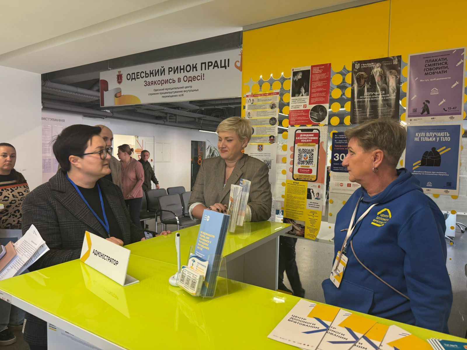 На фото жінки спілкуються в центрі надання адмінпослуг