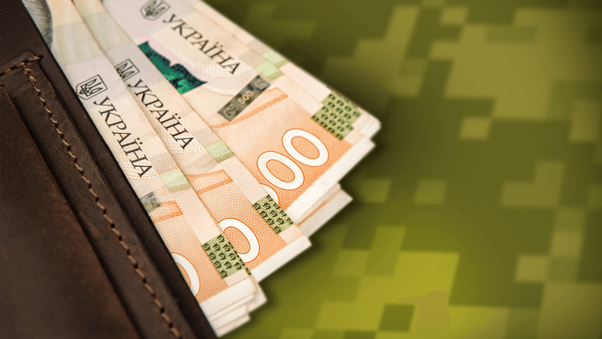 На фото зображено гаманець, в якому лежать купюри по 100 грн